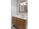 Bathroom featuring an oak cabinet, white countertop and walls, and a framed mirror at 1841 Shady Ln, Martinsville, IN 46151