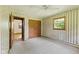 Bedroom with neutral carpet, window, ceiling fan and access to the ensuite at 1841 Shady Ln, Martinsville, IN 46151