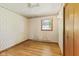 Bedroom featuring a ceiling fan, hardwood floors, and light floral wallpaper at 1841 Shady Ln, Martinsville, IN 46151