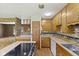 Bright kitchen featuring wood cabinets, laminate countertops, and a functional layout at 1841 Shady Ln, Martinsville, IN 46151