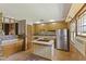 Bright kitchen with an island cooktop, stainless steel appliances, and ample storage at 1841 Shady Ln, Martinsville, IN 46151