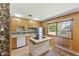 Functional kitchen with an island cooktop, wood cabinets, and lots of natural light at 1841 Shady Ln, Martinsville, IN 46151