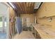 Storage room with pegboard walls, wood shelving, and a small workbench at 1841 Shady Ln, Martinsville, IN 46151