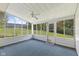 Enclosed sunroom with large windows, ceiling fan, and view of the backyard at 1841 Shady Ln, Martinsville, IN 46151