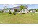 Spacious backyard with green lawn is enhanced by trees and a shaded patio area at 19195 River Jordan Dr, Westfield, IN 46074