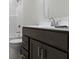 Bathroom featuring dark wood vanity with white countertop, modern faucet, and a shower/tub at 19195 River Jordan Dr, Westfield, IN 46074