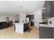 Spacious open kitchen with hardwood flooring, central island with seating, and modern appliances at 19195 River Jordan Dr, Westfield, IN 46074