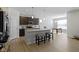 Open kitchen with hardwood floors, a kitchen island with seating, and modern lighting at 19195 River Jordan Dr, Westfield, IN 46074
