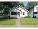 Charming single-story home featuring a screened-in porch and a well-maintained front yard at 2025 Fairview St, Anderson, IN 46016