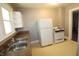 Functional kitchen with ample counter space, a double basin sink, white appliances and neutral walls at 2025 Fairview St, Anderson, IN 46016