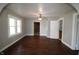 Bright and airy living room with hardwood floors, a ceiling fan, and archway into adjacent rooms at 2025 Fairview St, Anderson, IN 46016