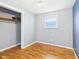 Cozy bedroom featuring light gray walls and hardwood floors at 203 Plum E St, Frankton, IN 46044