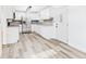 Updated kitchen with stainless steel appliances, white cabinetry, and modern gray backsplash at 203 Plum E St, Frankton, IN 46044