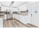 Well-lit kitchen featuring stainless steel appliances, new cabinetry and door to exterior at 203 Plum E St, Frankton, IN 46044