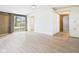 Spacious living room featuring light wood flooring, bright windows, and neutral paint at 203 Plum E St, Frankton, IN 46044