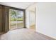 Open living room featuring sliding glass doors, neutral paint, and light wood flooring at 203 Plum E St, Frankton, IN 46044