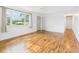 Bright living room featuring hardwood floors, large window and front door at 203 Plum E St, Frankton, IN 46044