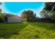 Wide backyard featuring abundant green grass and trees at 207 E Waterbury Rd, Indianapolis, IN 46227