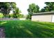 Expansive backyard featuring lush green grass and mature trees at 207 E Waterbury Rd, Indianapolis, IN 46227