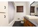 Clean bathroom features a tub/shower combo, updated fixtures, and a neutral color palette at 207 E Waterbury Rd, Indianapolis, IN 46227