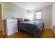 Inviting bedroom boasts hardwood floors, natural light, and a closet for ample storage at 207 E Waterbury Rd, Indianapolis, IN 46227