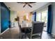 Open dining area features stylish table set, modern lighting, blue accent wall, and natural light at 207 E Waterbury Rd, Indianapolis, IN 46227