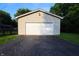 Front view of an attached two car garage with attached driveway at 207 E Waterbury Rd, Indianapolis, IN 46227