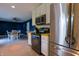 Updated kitchen features stainless steel appliances, white cabinets, and an open dining area for easy entertaining at 207 E Waterbury Rd, Indianapolis, IN 46227