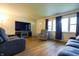 Bright living room with hardwood floors and large windows, offering plenty of natural light at 207 E Waterbury Rd, Indianapolis, IN 46227