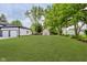 Expansive backyard features lush green grass, mature trees, and a shed in the background at 2125 N Pasadena St, Indianapolis, IN 46219