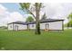 Large backyard features lush green grass, mature trees, and house in the background at 2125 N Pasadena St, Indianapolis, IN 46219