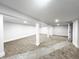 Unfinished basement with carpet and white support pillars ready for your personal touch at 2125 N Pasadena St, Indianapolis, IN 46219