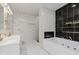 Modern bathroom features dual vanities, jacuzzi tub, and beautifully tiled shower creating a spa-like experience at 2125 N Pasadena St, Indianapolis, IN 46219