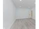 Spacious bedroom with light gray flooring, recessed lighting, and a white door at 2125 N Pasadena St, Indianapolis, IN 46219