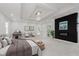 Bright bedroom features tray ceilings, stylish decor, and access to ensuite bathroom, perfect for unwinding after a long day at 2125 N Pasadena St, Indianapolis, IN 46219