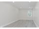 Bright bedroom featuring light gray flooring, neutral paint, and ample natural light at 2125 N Pasadena St, Indianapolis, IN 46219