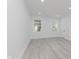 Bright bedroom featuring stylish gray flooring, multiple light-filled windows, and neutral decor at 2125 N Pasadena St, Indianapolis, IN 46219
