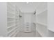 Walk-in closet with ample shelving and storage drawers, designed for organizing and maximizing space at 2125 N Pasadena St, Indianapolis, IN 46219