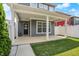 Covered back porch with white columns, gray siding, and a view of the fenced-in backyard at 214 Handley St, Indianapolis, IN 46222