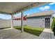 Charming covered patio with concrete floor, white fence, and a view of the detached garage and well-maintained lawn at 214 Handley St, Indianapolis, IN 46222