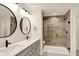 Bathroom featuring a double sink vanity with modern faucets and a stylish walk-in shower with tiled walls at 214 Handley St, Indianapolis, IN 46222