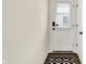 A clean entryway featuring a dutch door, and a modern patterned rug on dark hardwood flooring at 214 Handley St, Indianapolis, IN 46222
