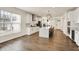 Bright and airy kitchen featuring white cabinets, stainless steel appliances, and a large island with seating at 214 Handley St, Indianapolis, IN 46222