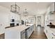 Modern, eat-in kitchen with large island, stainless appliances, sleek white cabinetry and designer light fixtures at 214 Handley St, Indianapolis, IN 46222