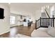 Open-concept living space with kitchen, island seating, and staircase with metal railing at 214 Handley St, Indianapolis, IN 46222