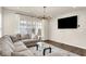 Bright living room featuring a comfortable L-shaped sofa, sleek glass coffee table and large flat screen TV at 214 Handley St, Indianapolis, IN 46222