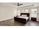 Spacious main bedroom with tray ceilings, a large bed, hardwood floors, and abundant natural light from multiple windows at 214 Handley St, Indianapolis, IN 46222
