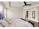 Bright main bedroom featuring a tray ceiling, hardwood floors, a view into the attached bathroom, and plenty of natural light at 214 Handley St, Indianapolis, IN 46222