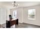 Bright home office featuring hardwood floors, natural light from two windows, and a modern desk with comfortable seating at 214 Handley St, Indianapolis, IN 46222