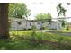 Backyard view with chain link fence, pool, and home exterior at 220 S 2Nd St, Summitville, IN 46070